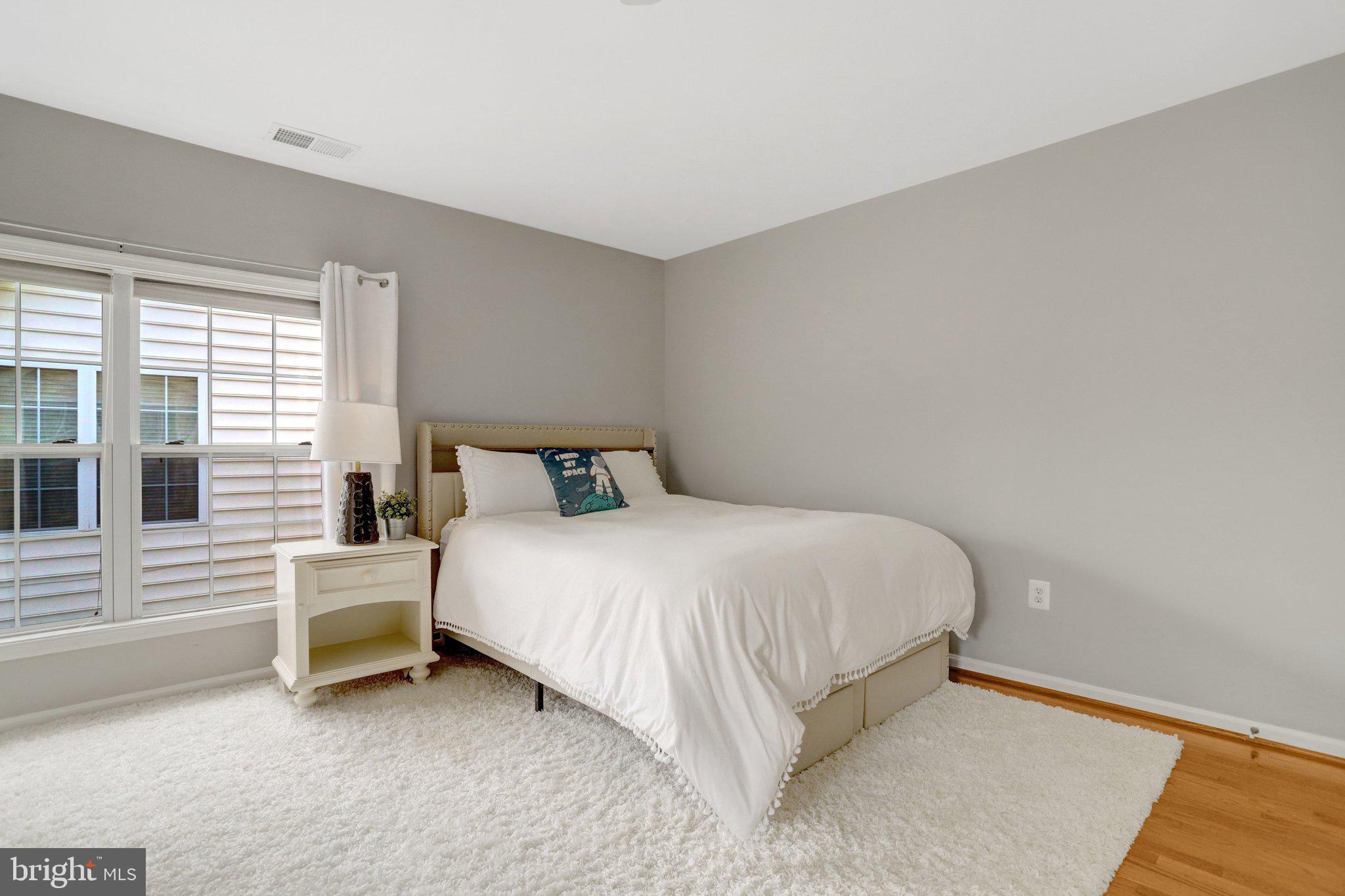 7374 Pohick Ridge Court Springfield, VA 22153 - Photo 28 of 58 a bedroom with a bed and a window