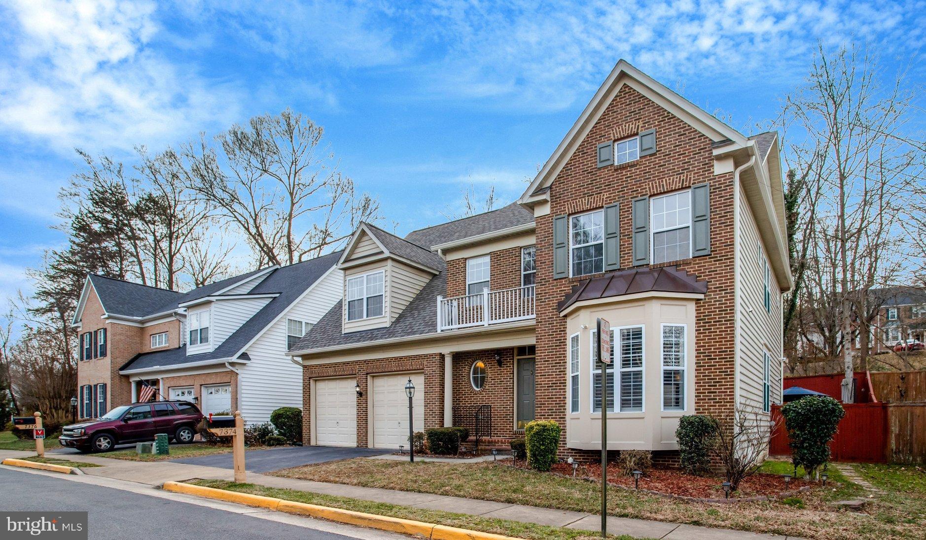 7374 Pohick Ridge Court Springfield, VA 22153 - Photo 3 of 58 a front view of a house with a yard