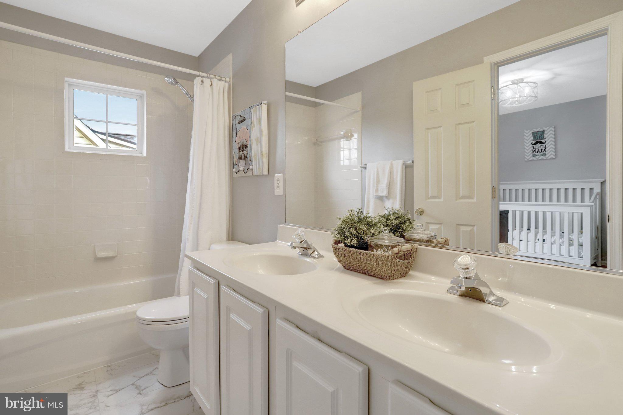 7374 Pohick Ridge Court Springfield, VA 22153 - Photo 35 of 58 a bathroom with a sink a toilet and shower