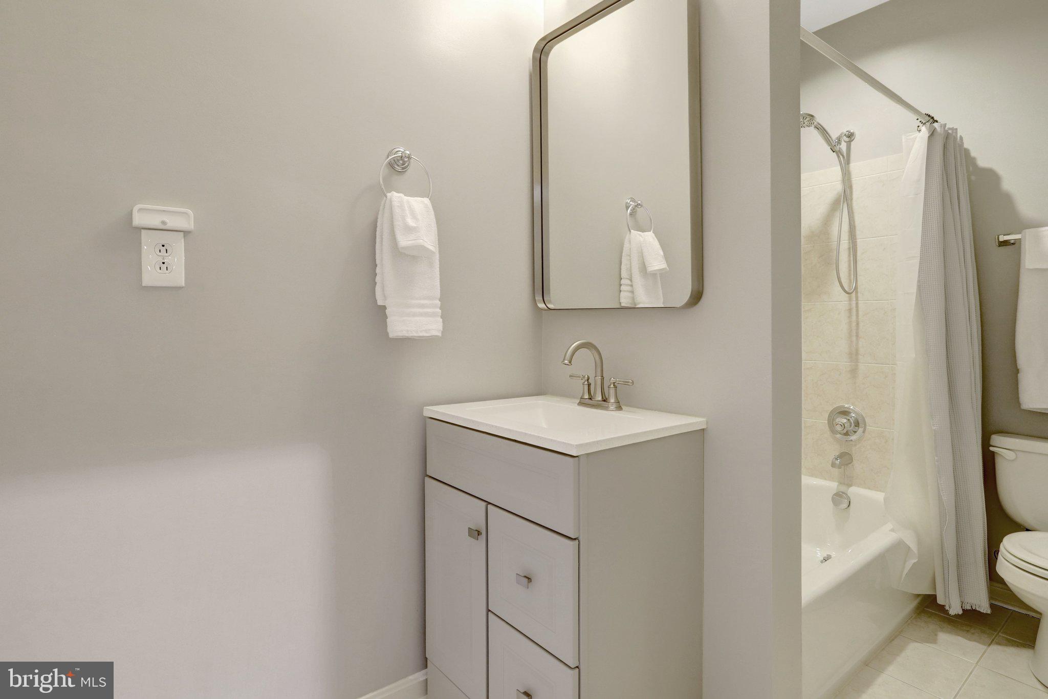 7374 Pohick Ridge Court Springfield, VA 22153 - Photo 40 of 58 a bathroom with a sink and mirror with toilet