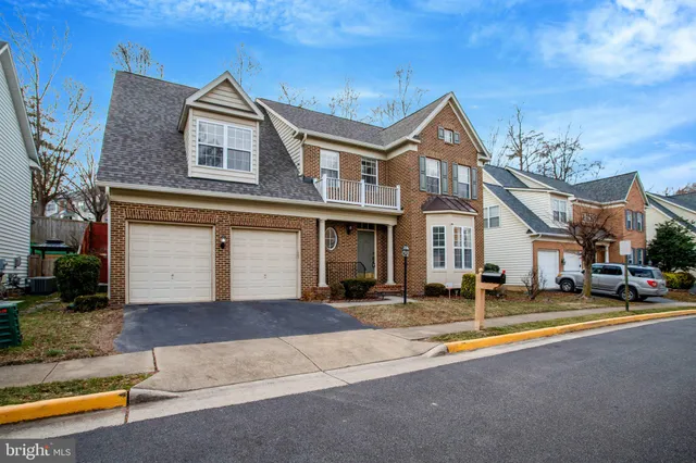 a front view of a house with garden and porch