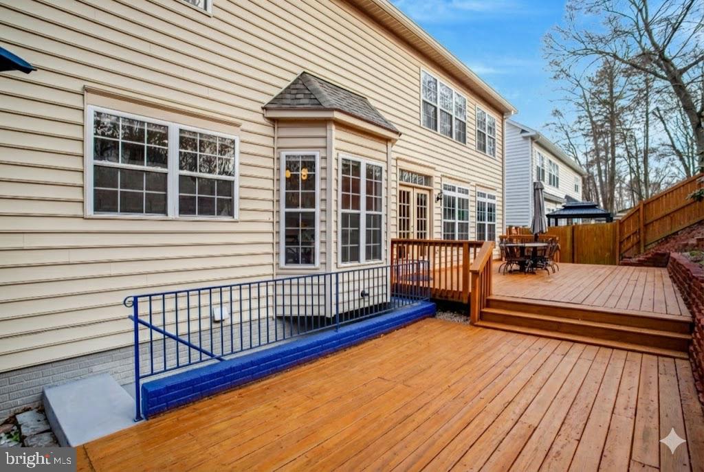 7374 Pohick Ridge Court Springfield, VA 22153 - Photo 53 of 58 a view of a wooden deck with a bench