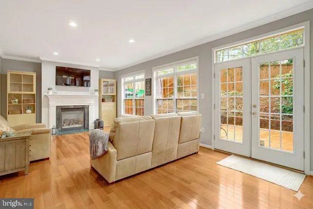 a living room with furniture and floor to ceiling windows