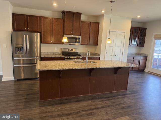711 Quarry Point Road Malvern, PA 19355 - Photo 7 of 26 a kitchen with kitchen island granite countertop wooden cabinets and refrigerator