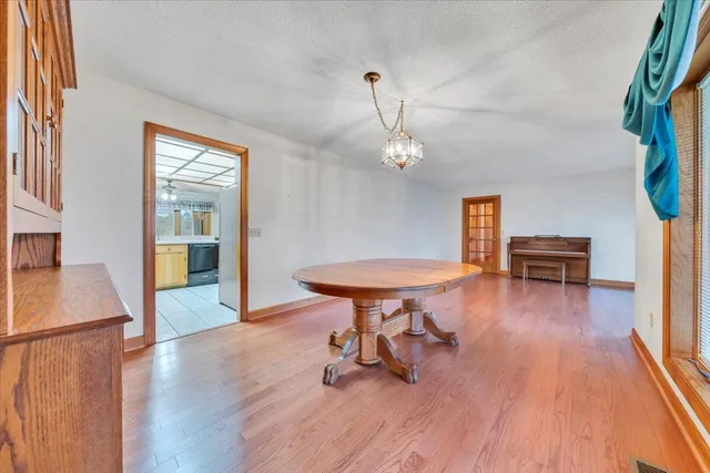 a bathroom with a granite countertop sink a mirror a toilet and shower