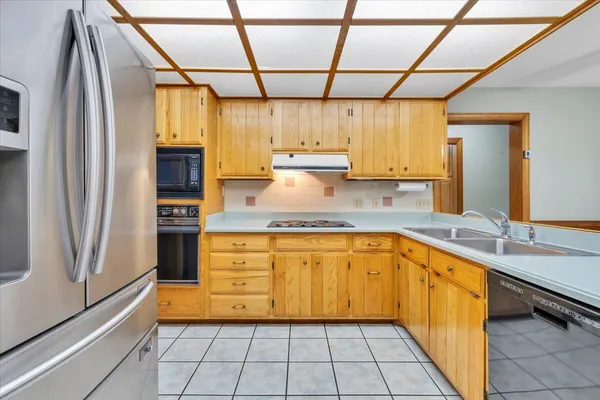a kitchen with stainless steel appliances granite countertop a sink and cabinets