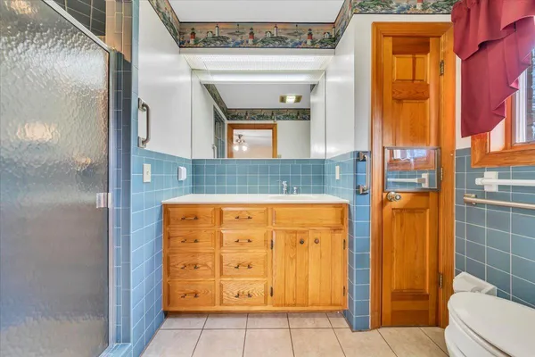 a kitchen with a sink a refrigerator and cabinets