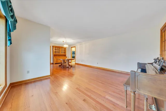 a view of a dining room with furniture and chandelier