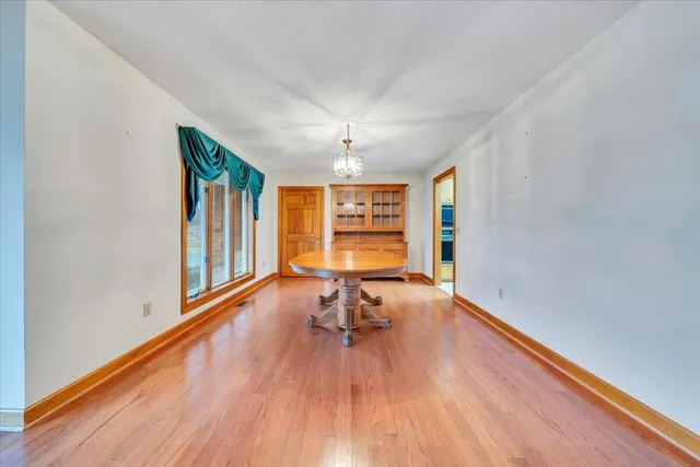 a living room with hard wood floors and a ceiling fan