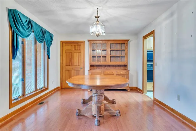 a view of an empty room with a window and bathroom