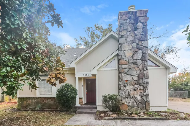 a view of a house with a tree