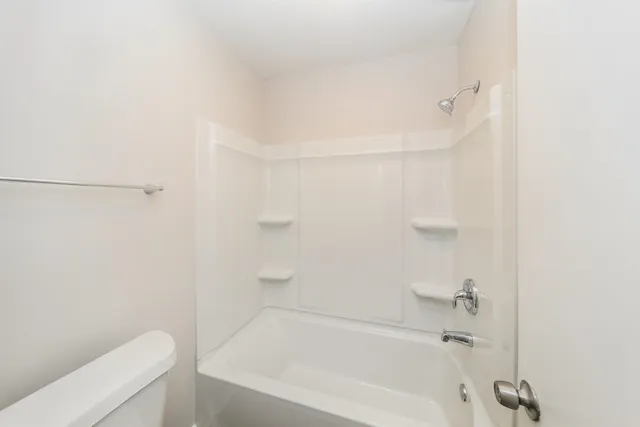 a bathroom with a bathtub and a toilet