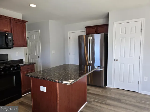 a kitchen with stainless steel appliances granite countertop a stove and a refrigerator