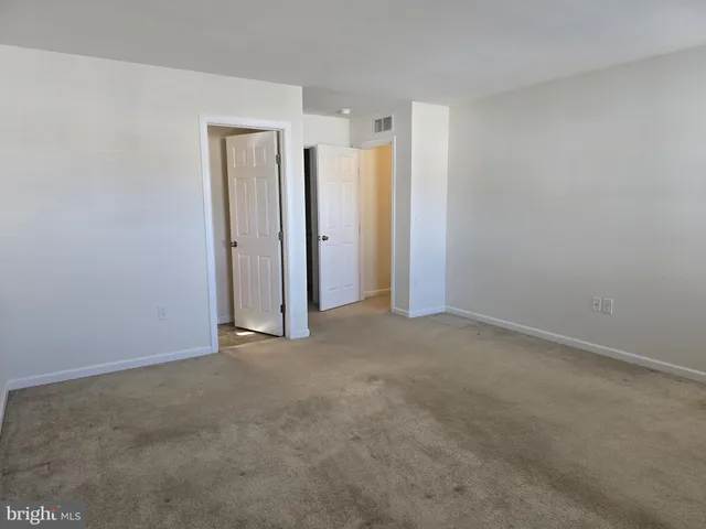 an empty room with closet area