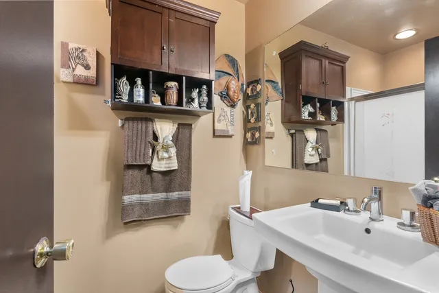a bathroom with a sink toilet and mirror