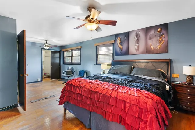 a bedroom with a large bed and a chandelier