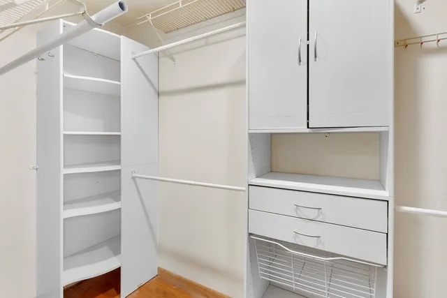 a view of walk in closet with empty racks