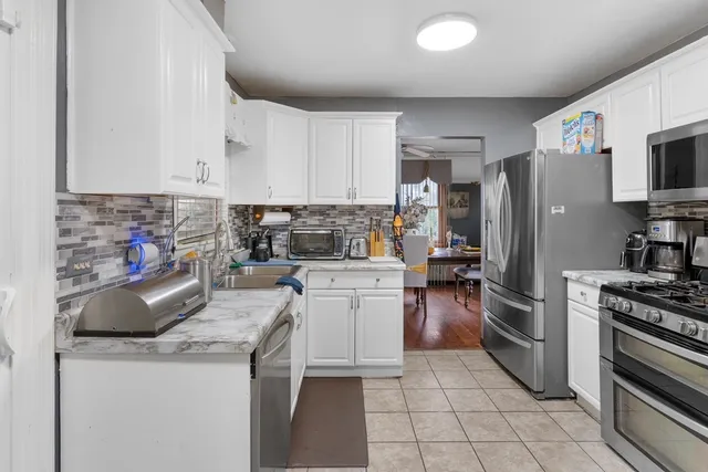 a kitchen with a sink a stove and refrigerator