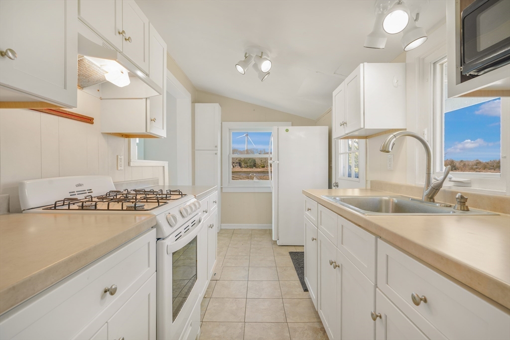 7 Shawmut Street Fairhaven, MA 02719 - Photo 11 of 39 a kitchen with a sink stove and refrigerator