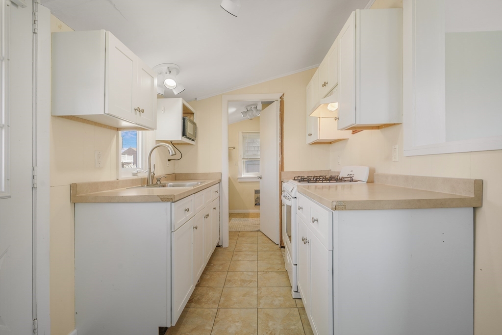 7 Shawmut Street Fairhaven, MA 02719 - Photo 12 of 39 a spacious bathroom with a granite countertop sink and a shower