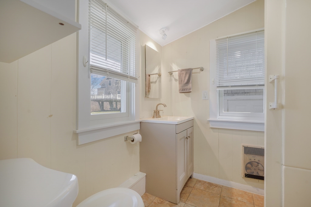7 Shawmut Street Fairhaven, MA 02719 - Photo 16 of 39 a bathroom with a sink a toilet and shower
