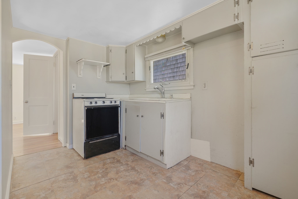 7 Shawmut Street Fairhaven, MA 02719 - Photo 27 of 39 a kitchen with stainless steel appliances a stove and white cabinets