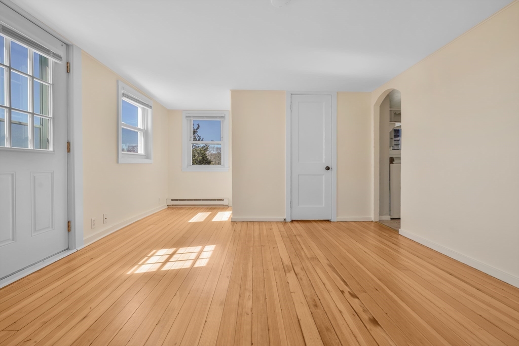 7 Shawmut Street Fairhaven, MA 02719 - Photo 29 of 39 a view of an empty room with wooden floor and a window