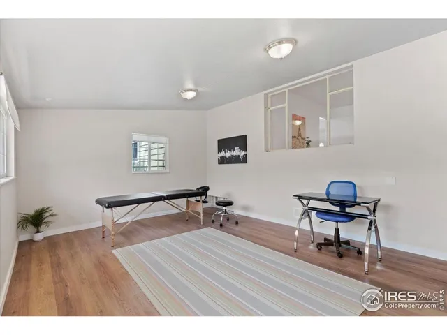 a workspace with furniture and wooden floor