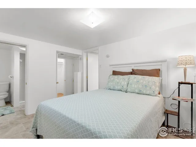 a bedroom with a bed and a chair