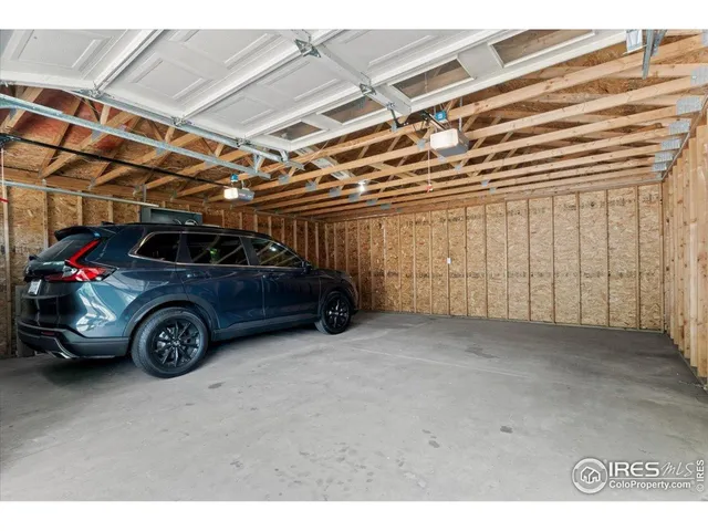 a view of garage with parked cars