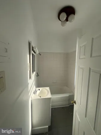 a bathroom with a shower and tub