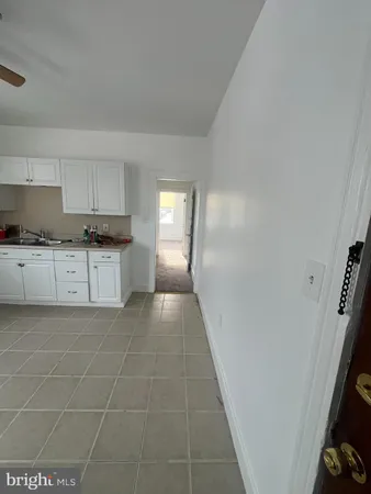 a kitchen with granite countertop a sink a stove and cabinets