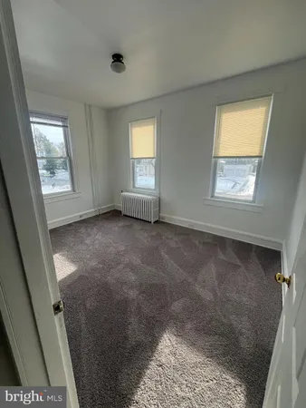 a view of an empty room with windows