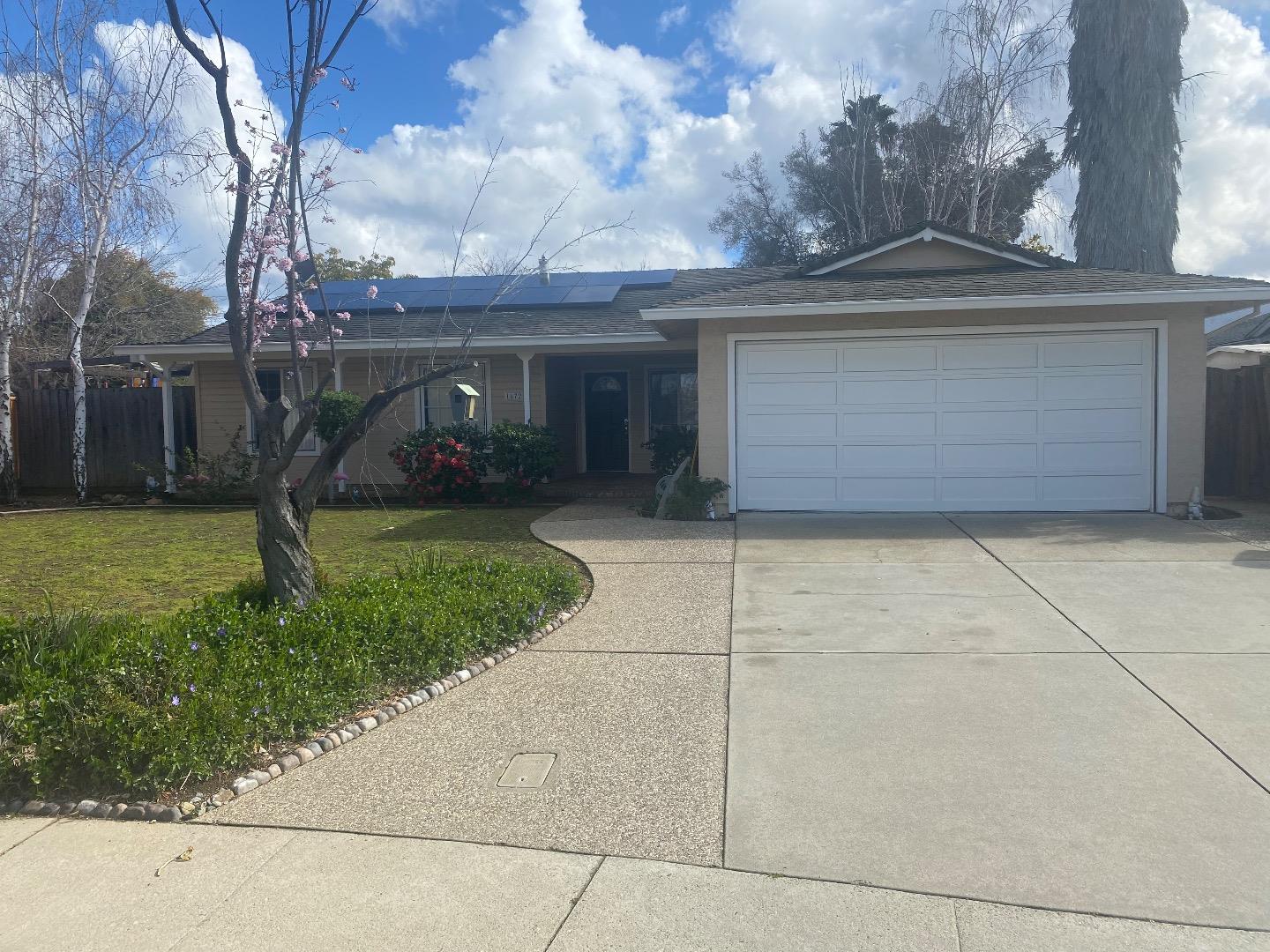 a view of a house with a yard and garage