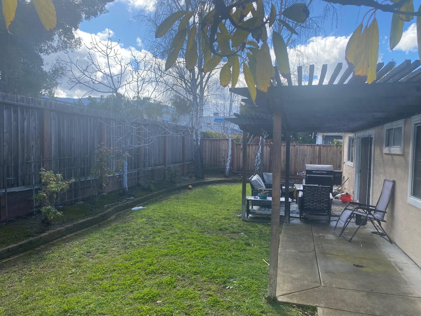 1672 Merrill Loop San Jose, CA 95124 - Photo 8 of 10 a view of a patio with table and chairs with wooden fence and plants