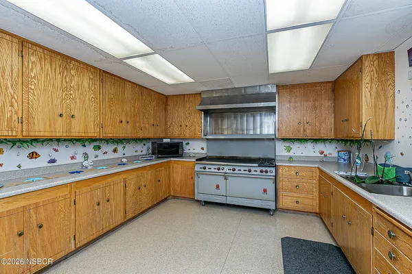 a living room with furniture and a book shelf
