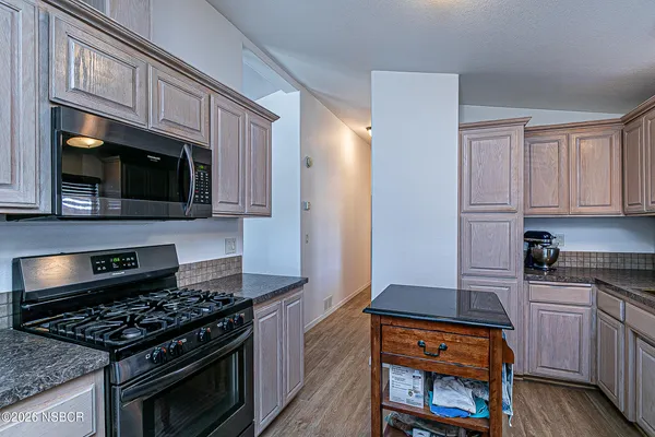 a kitchen with counter top space cabinets and appliances
