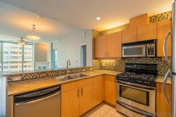 a kitchen that has a sink and a stove