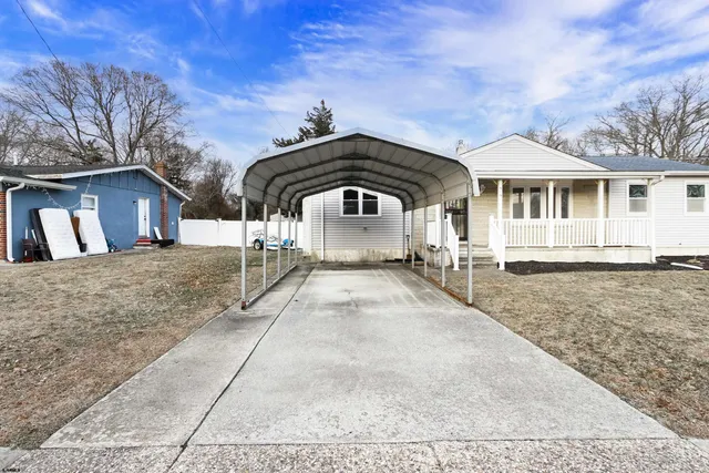 a view of backyard of house with outdoor seating
