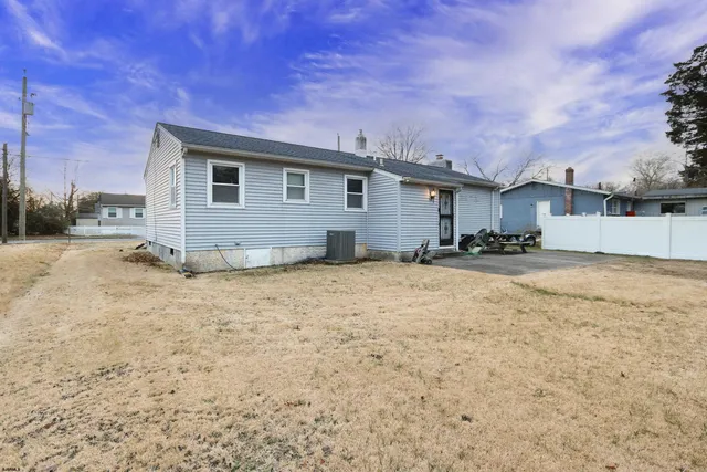 a view of a house with a backyard