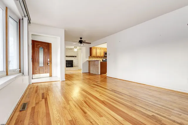 a view of empty room with wooden floor and fire pit