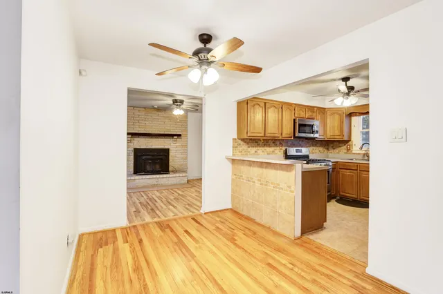 a view of kitchen with sink microwave and refrigerator