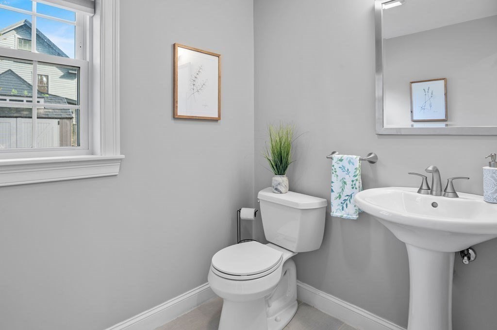 27 Warren Street, Unit 1 Newburyport, MA 01950 - Photo 18 of 32 a white toilet sitting next to a bathroom sink