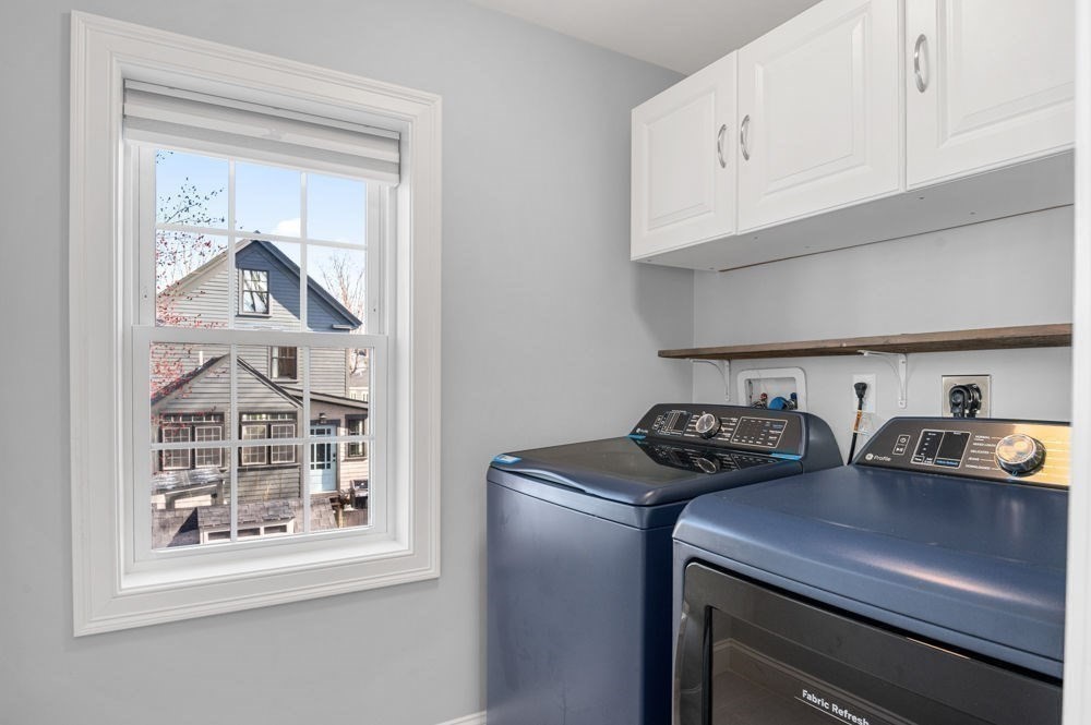 27 Warren Street, Unit 1 Newburyport, MA 01950 - Photo 19 of 32 a kitchen with stainless steel appliances a stove a white cabinet and a granite countertops with wooden floor