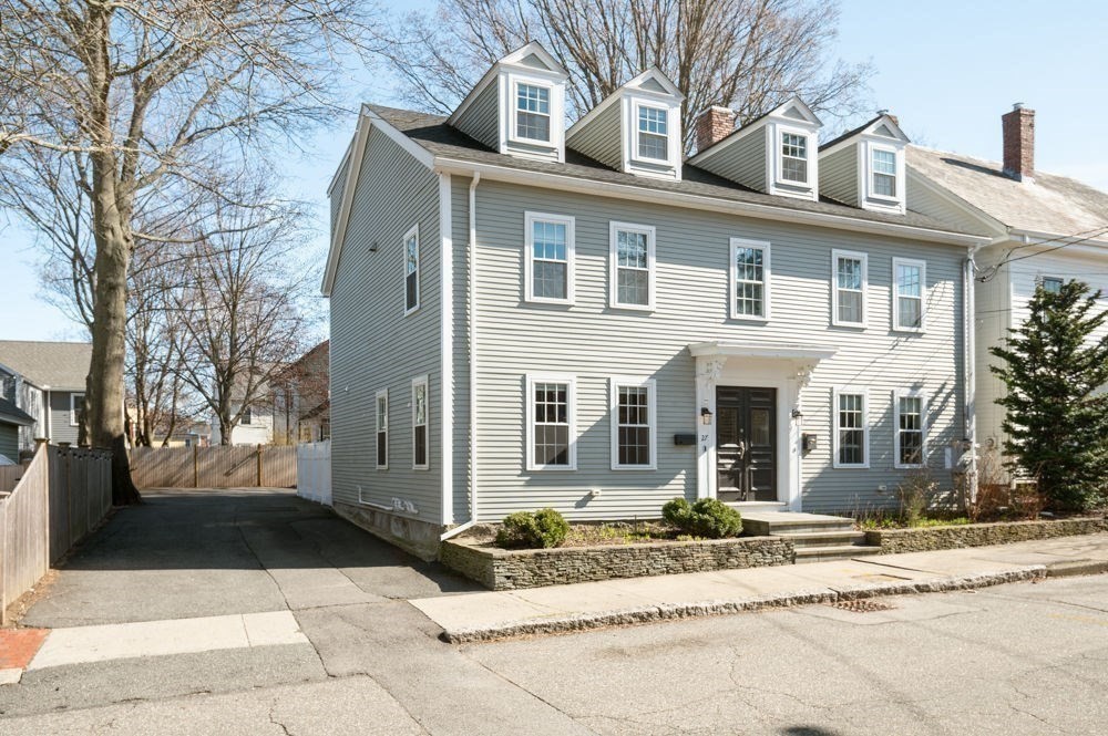 27 Warren Street, Unit 1 Newburyport, MA 01950 - Photo 2 of 32 a front view of a house with a yard and potted plants