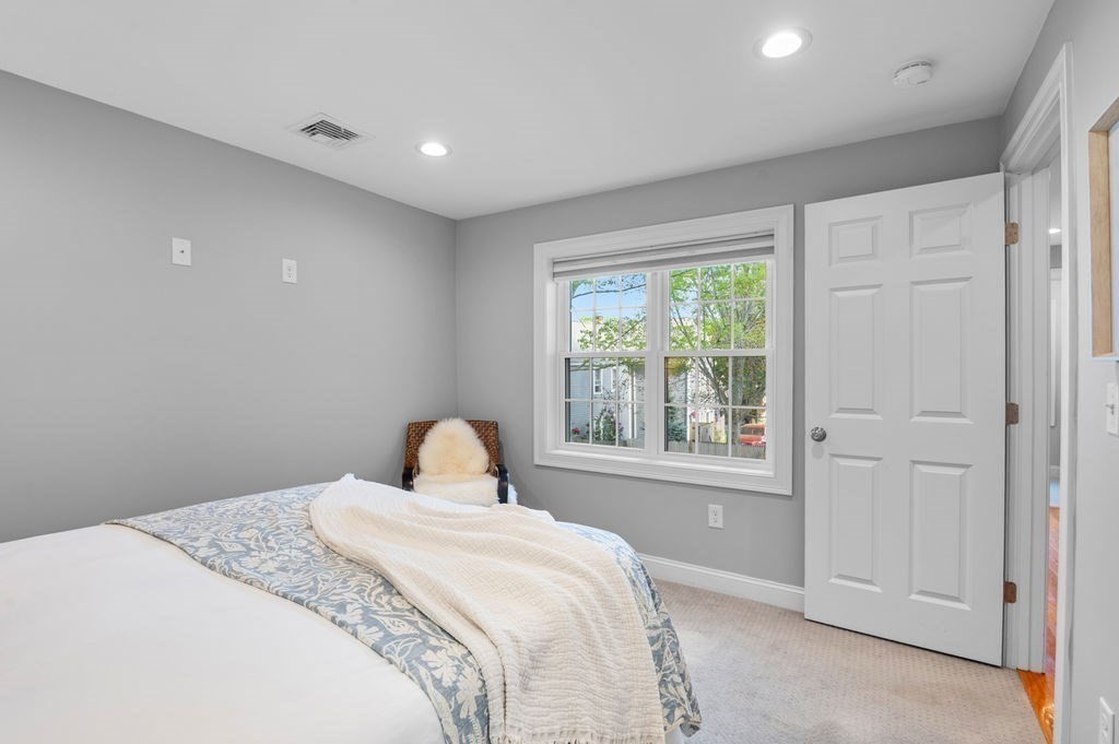 27 Warren Street, Unit 1 Newburyport, MA 01950 - Photo 21 of 32 a bedroom with a large bed and a window