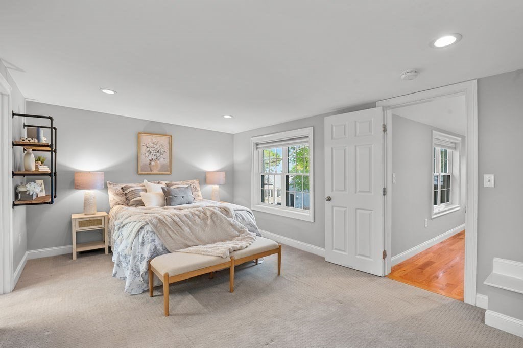 27 Warren Street, Unit 1 Newburyport, MA 01950 - Photo 26 of 32 a bedroom with a bed and a couch