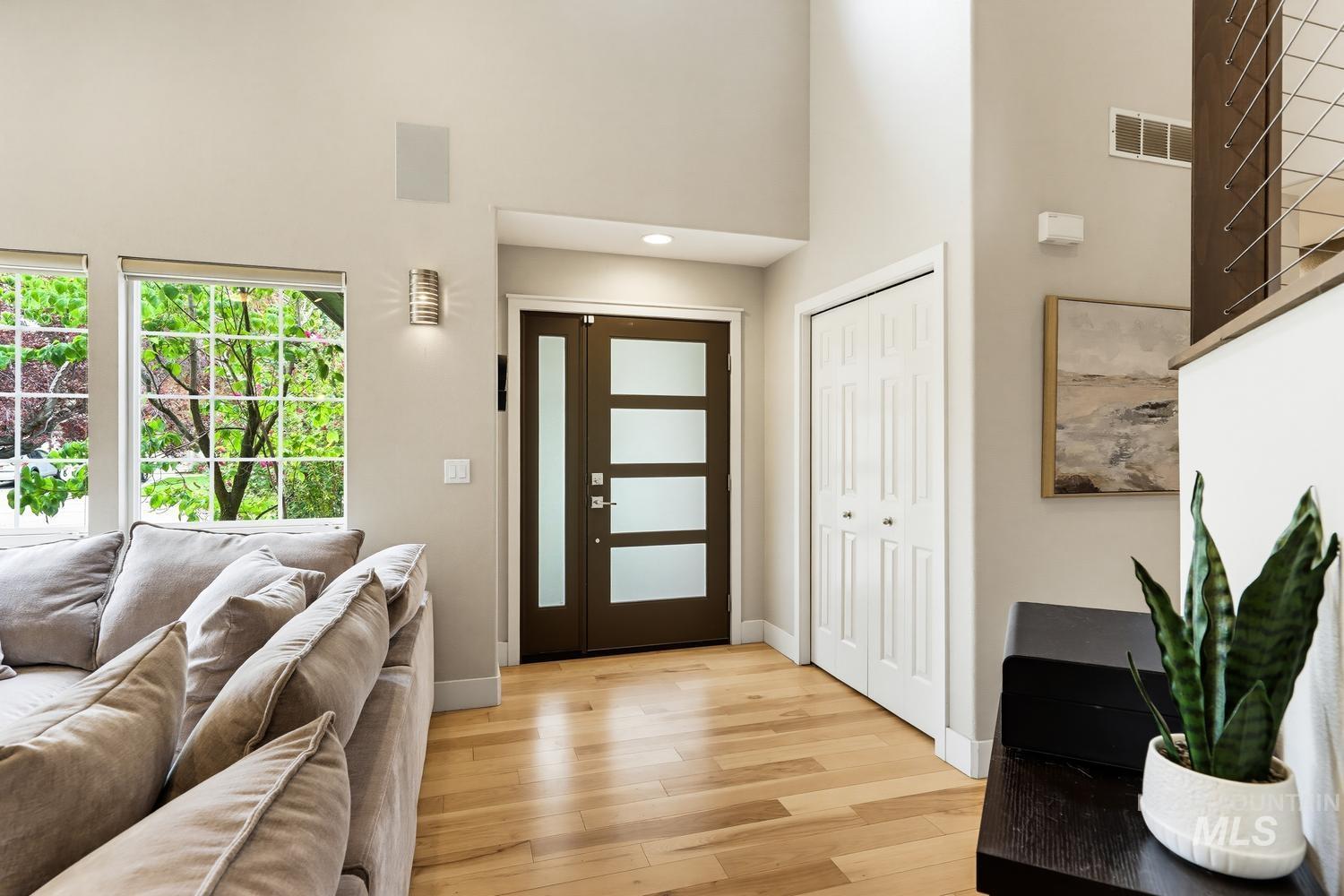 369 South Winthrop Way Boise, ID 83709 - Photo 3 of 50 Entryway featuring a modern frosted glass door, light wood-finish flooring, high ceilings, and recessed lighting