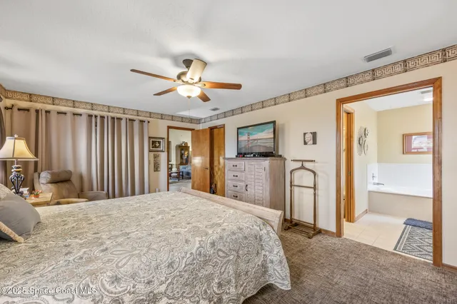 a bedroom with a bed dresser and a window