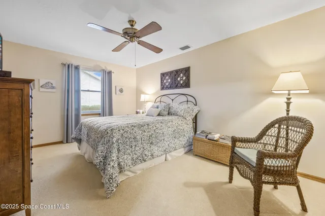 a bedroom with a bed a bed and a chandelier